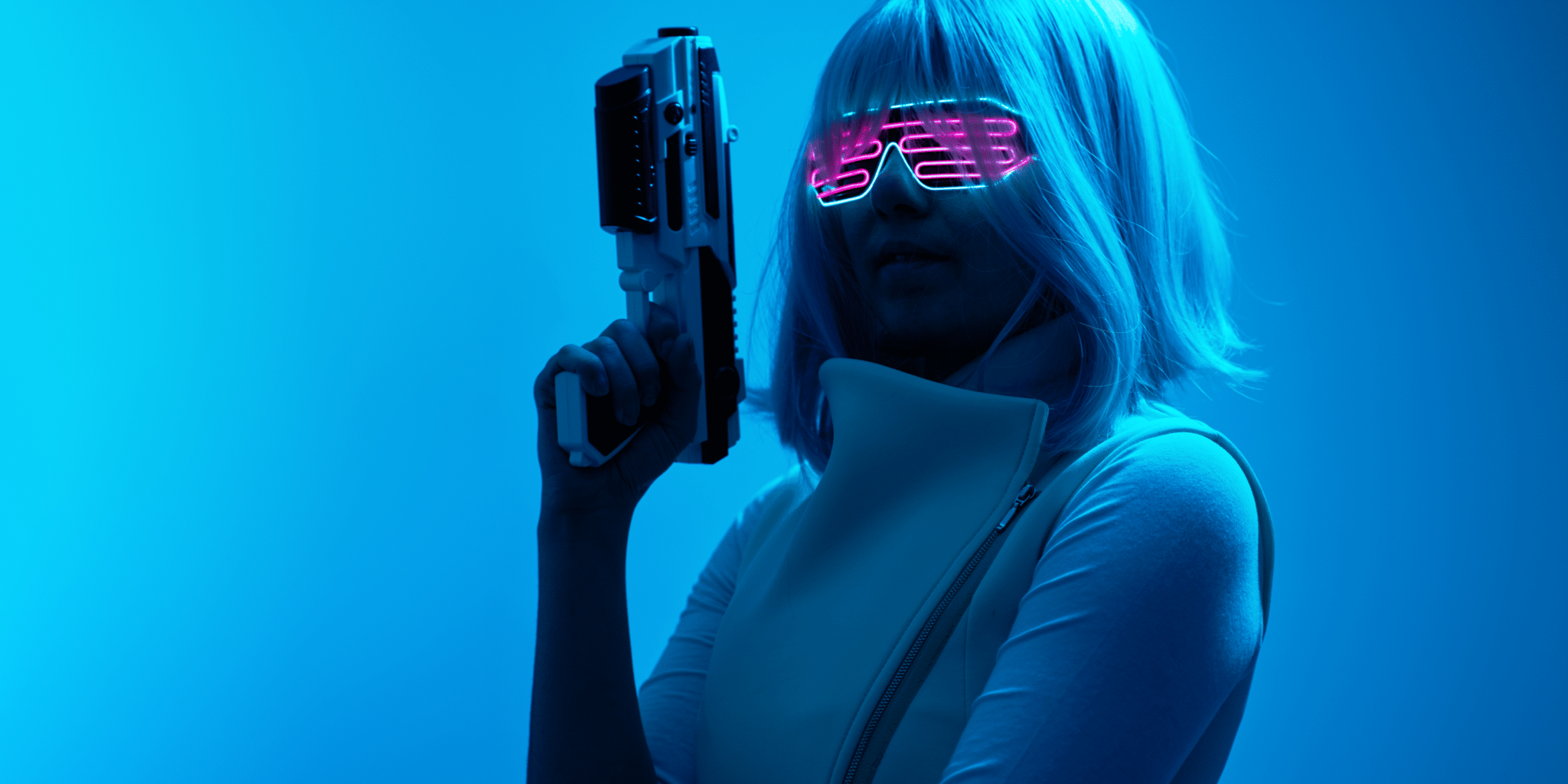 A girl in costume holding a gel blaster